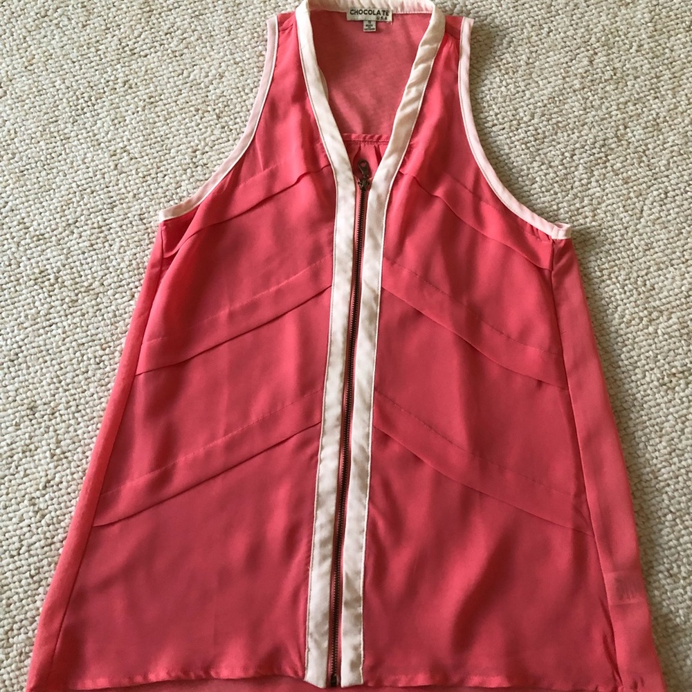 Blouse it’s lots of details. Color is coral with beige piping. Very slimming.